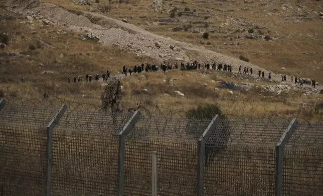 Syrian Druze protest near the Israeli-Syrian border, as seen from the town of Majdal Shams in the Israeli-controlled Golan Heights, Wednesday, July 16, 2025, amid the ongoing clashes between Syrian government forces and Druze armed groups in the southern Syrian city of Sweida. (AP Photo/Leo Correa)