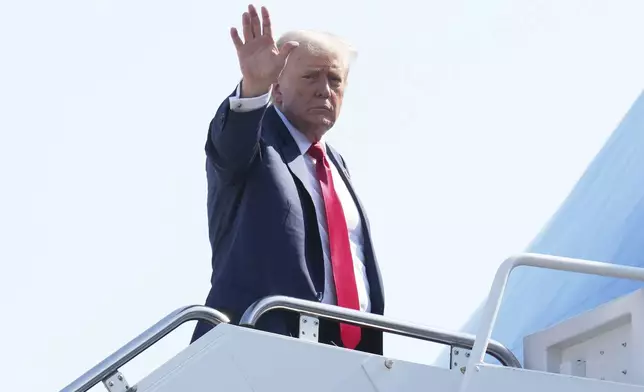 President Donald Trump waves as he boards Air Force One at Joint Base Andrews, Md., Friday, July 25, 2025, en route to Scotland. (AP Photo/Jacquelyn Martin)