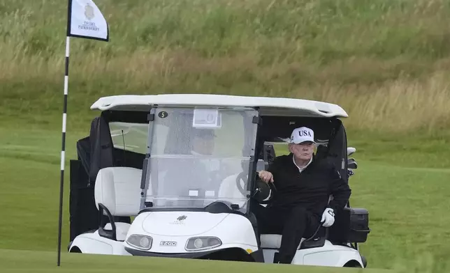 President Donald Trump steers a golf cart at the Trump Turnberry golf course in Turnberry, Scotland, Saturday, July 26, 2025.(AP Photo/Alastair Grant)