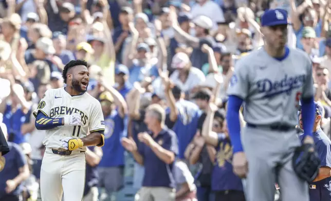 Milwaukee Brewers' Jackson Chourio (11) reacts after his game-winning single during the 10th inning of a baseball game against the Los Angeles Dodgers, Wednesday, July 9 2025, in Milwaukee. (AP Photo/Jeffrey Phelps)