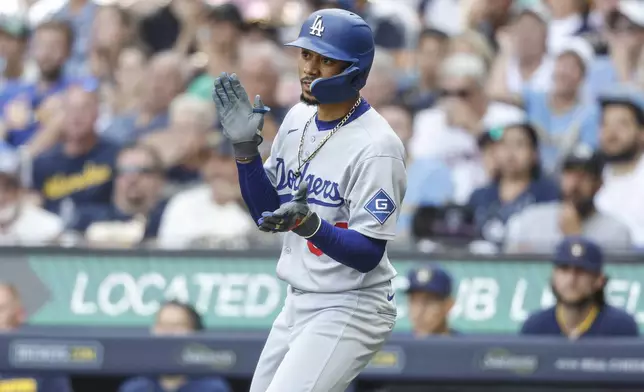 Los Angeles Dodgers' Mookie Betts reacts after he hit a run scoring sacrifice fly against the Milwaukee Brewers during the seventh inning of a baseball game, Wednesday, July 9 2025, in Milwaukee. (AP Photo/Jeffrey Phelps)