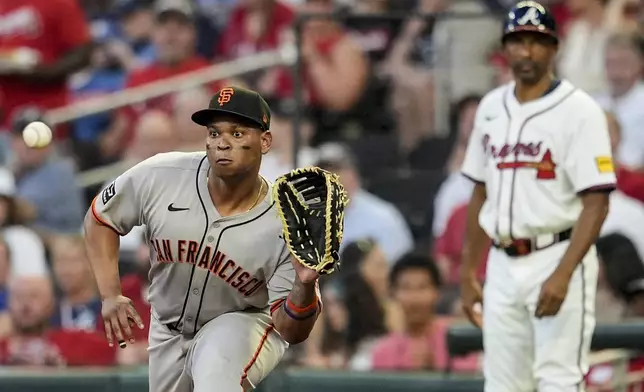 San Francisco Giants' Rafael Devers (16) makes the tag on Atlanta Braves' Nick Allen (2) at first base in the fifth inning of a baseball game, Tuesday, July 22, 2025, in Atlanta. (AP Photo/Mike Stewart)