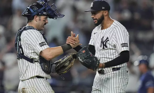 New York Yankees pitcher Devin Williams, right, celebrates with catcher Austin Wells after a baseball game against the Tampa Bay Rays Tuesday, July 29, 2025, in New York. (AP Photo/Frank Franklin II)