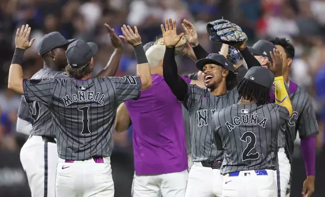 The New York Mets celebrate after a comeback win over the Los Angeles Angels in a baseball game, Monday, July 21, 2025, in New York. (AP Photo/Heather Khalifa)