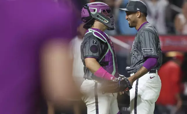 New York Mets pitcher Edwin Díaz, right, and catcher Francisco Alvarez, left, react after a win over the Los Angeles Angels in a baseball game, Monday, July 21, 2025, in New York. (AP Photo/Heather Khalifa)