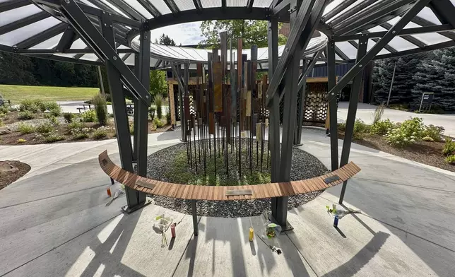 During their memorial, flowers and candles are seen below the names of the University of Idaho students who were killed in November 2022 at their off campus house in Moscow, Idaho, Tuesday, July 1, 2025. (AP Photo/Manuel Valdes)