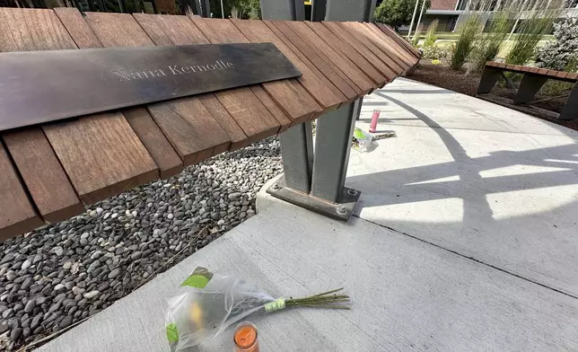 A flower and a candle were left below the name plaque for Xana Kernodle, one of the four University of Idaho students killed in November 2022 at their off campus house in Moscow, Idaho, on Tuesday, July 1, 2025. (AP Photo/Manuel Valdes)