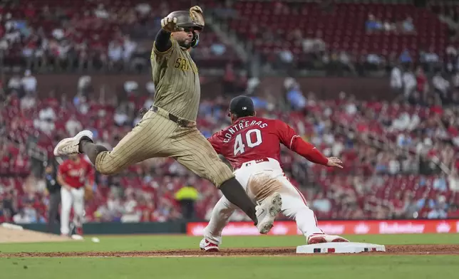 San Diego Padres' Xander Bogaerts, left, grounds out as St. Louis Cardinals first baseman Willson Contreras (40) handles the throws to end the top of the eighth inning of a baseball game Friday, July 25, 2025, in St. Louis. (AP Photo/Jeff Roberson)