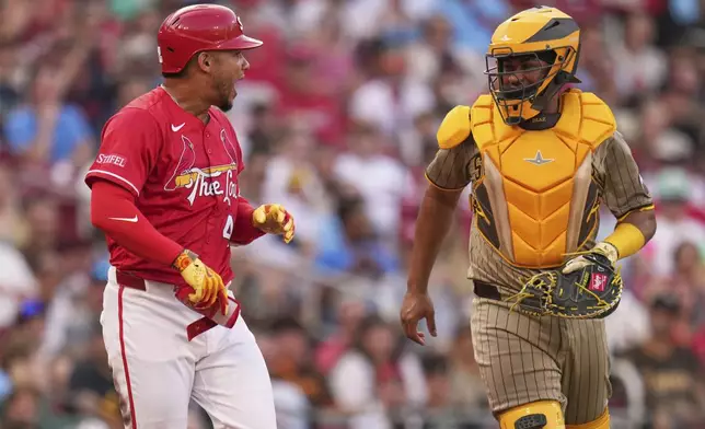 St. Louis Cardinals' Willson Contreras, left, yells after being hit by a pitch from San Diego Padres starting pitcher Nick Pivetta as Padres catcher Elias Diaz, right, steps between the two during the second inning of a baseball game Friday, July 25, 2025, in St. Louis. (AP Photo/Jeff Roberson)