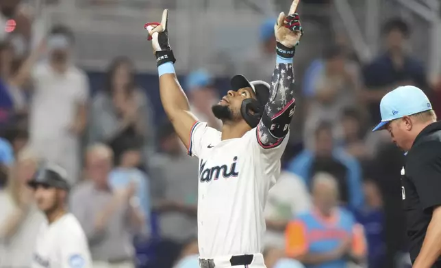 Miami Marlins' Otto Lopez crosses the plate after hitting a two-run home run during the fifth inning of a baseball game against the Milwaukee Brewers, Friday, July 4, 2025, in Miami. (AP Photo/Lynne Sladky)