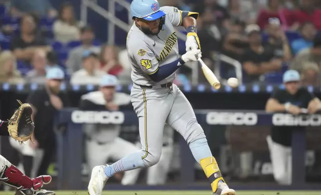 Milwaukee Brewers' Jackson Chourio hits a RBI double to score Christian Yelich during the eighth inning of a baseball game against the Miami Marlins, Friday, July 4, 2025, in Miami. (AP Photo/Lynne Sladky)