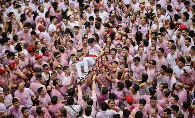 Revelers pack the main square during the start of nine days of uninterrupted partying in Pamplona's famed running-of-the-bulls festival in Pamplona, Spain, Sunday, July 6, 2025. (AP Photo/Miguel Oses)