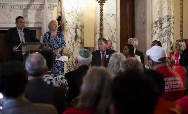 Rhode Island House Speaker K. Joseph Shekarchi, left, addresses a crowd gathered to witness Gov. Dan McKee sign a bill that bans the sale of assault-style weapons in the state of Rhode Island at the Rhode Island Statehouse in Providence, Thursday, June 26, 2025. (AP Photo/Sydney Roth)