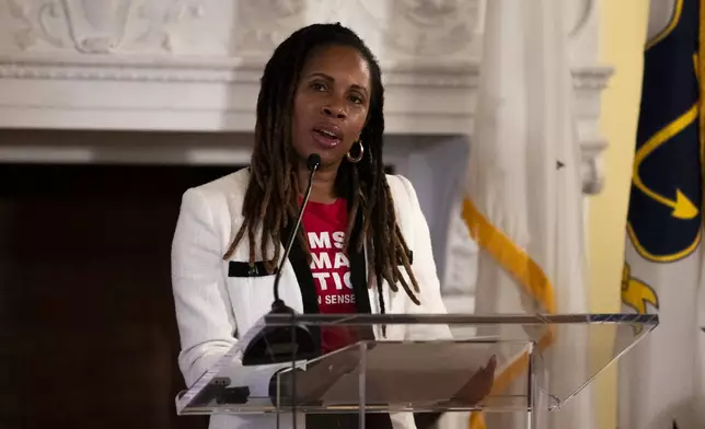Angela Ferrell-Zabala, executive director of Moms Demand Action, addresses a crowd gathered to witness Rhode Island Gov. Dan McKee sign a bill that bans the sale of assault-style weapons in the state of Rhode Island at the Rhode Island Statehouse in Providence, Thursday, June 26, 2025. (AP Photo/Sydney Roth)