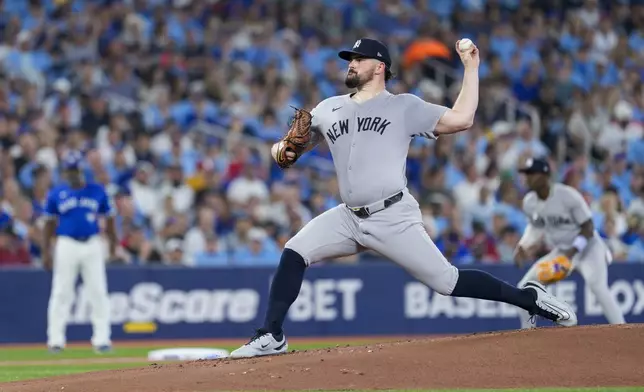 New York Yankees pitcher Carlos Rodon throws against the Toronto Blue Jays during first-inning baseball game action in Toronto, Monday, June 30, 2025. (Thomas Skrlj/The Canadian Press via AP)