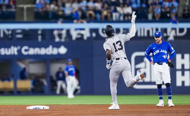 New York Yankees' Jazz Chisholm Jr. (13) celebrates after his two-run home run against the Toronto Blue Jays during fourth-inning baseball game action in Toronto, Monday, June 30, 2025. (Thomas Skrlj/The Canadian Press via AP)