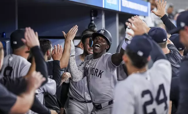 New York Yankees' Jazz Chisholm Jr., center, celebrates after his two-run home run against the Toronto Blue Jays during fourth-inning baseball game action in Toronto, Monday, June 30, 2025. (Thomas Skrlj/The Canadian Press via AP)