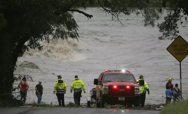 CORRECTS DAY - First responders scan the banks of the Guadalupe River for individuals swept away by flooding in Ingram, Texas, Friday, July 4, 2025. (Michel Fortier/The San Antonio Express-News via AP)