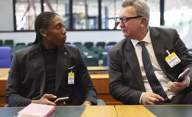 South Africa's Caster Semenya speaks to lawyer Gregory Nott, right, in the European Court of Human Rights before a decision over sex eligibility rules in sports, Thursday, July 10, 2025 in Strasbourg, eastern France. (AP Photo/Antonin Utz)