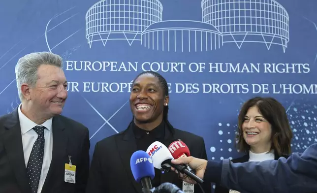 South Africa's Caster Semenya, center, answers reporters with lawyers Gregory Nott, left, and Shona Jolly KC after Semenya won a partial victory at the European Court of Human Rights on in her seven-year legal fight against track and field's sex eligibility rules, Thursday, July 10, 2025 in Strasbourg, eastern France. (AP Photo/Antonin Utz)