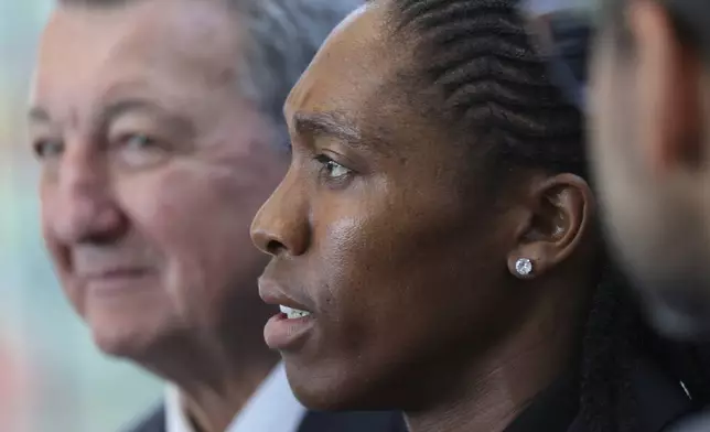 South Africa's Caster Semenya, center, answers reporters with lawyer Gregory Nott, left, after Semenya won a partial victory at the European Court of Human Rights on in her seven-year legal fight against track and field's sex eligibility rules, Thursday, July 10, 2025 in Strasbourg, eastern France. (AP Photo/Antonin Utz)