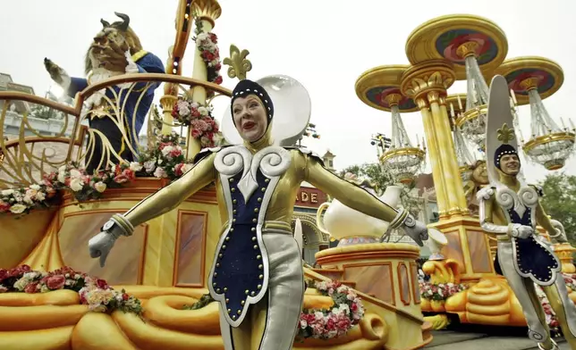 FILE - The "Beauty and the Beast" float, along with supporting characters, entertains visitors to Disneyland during "Walt Disney's Parade of Dreams" in Anaheim, Calif., May 4, 2005. (AP Photo/Ric Francis, File)