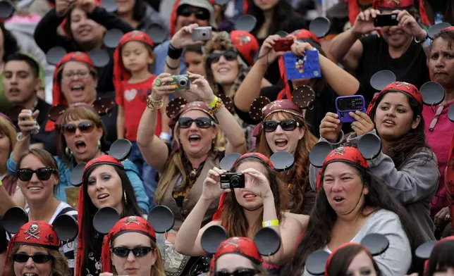 FILE - Fans cheer and take pictures as Mickey Mouse arrives at the World Premiere of "Pirates of the Caribbean: On Stranger Tides" at Disneyland in Anaheim, Calif., May 7, 2011. (AP Photo/Chris Pizzello, File)