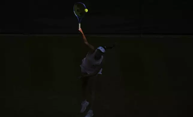 Elise Mertens of Belgium serves to Elina Svitolina of Ukraine during their women's singles third round match at the Wimbledon Tennis Championships in London, Friday, July 4, 2025.(AP Photo/Alastair Grant)