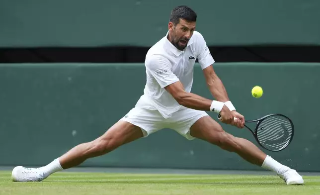 Novak Djokovic of Serbia returns to Miomir Kecmanovic of Serbia during a third round men's singles match at the Wimbledon Tennis Championships in London, Saturday, July 5, 2025. (AP Photo/Kirsty Wigglesworth)