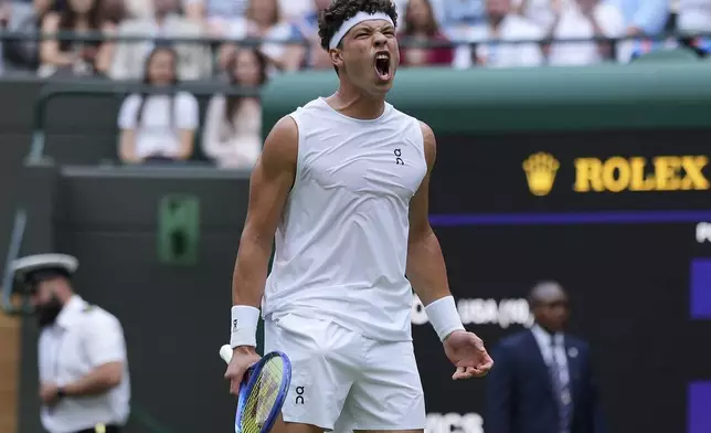 Ben Shelton of the U.S. celebrates winning a set during his men's singles third round match against Marton Fucsovics of Hungary at the Wimbledon Tennis Championships in London, Saturday, July 5, 2025.(AP Photo/Alastair Grant)