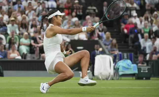 Emma Raducanu of Britain slips and falls attempting to return to Aryna Sabalenka of Belarus during a third round women's singles match at the Wimbledon Tennis Championships in London, Friday, July 4, 2025. (AP Photo/Kin Cheung)