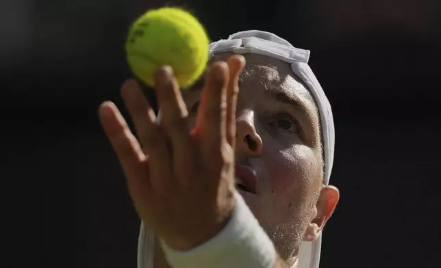 Jan-Lennard Struff of Germany serves to Carlos Alcaraz of Spain during a third round men's singles match at the Wimbledon Tennis Championships in London, Friday, July 4, 2025. (AP Photo/Kin Cheung)