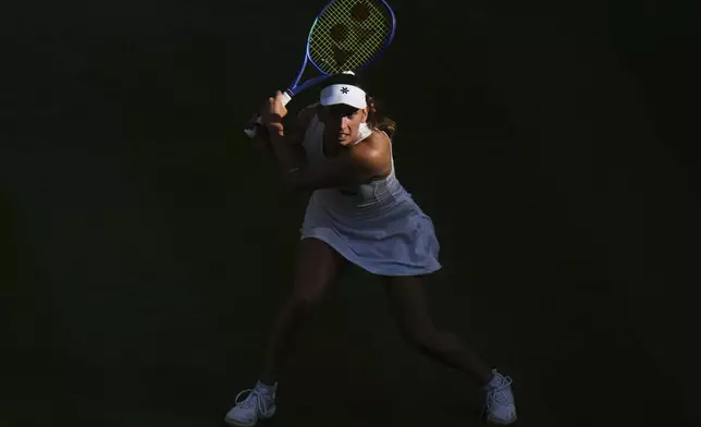 Elise Mertens of Belgium plays a return to Elina Svitolina of Ukraine during their women's singles third round match at the Wimbledon Tennis Championships in London, Friday, July 4, 2025.(AP Photo/Alastair Grant)