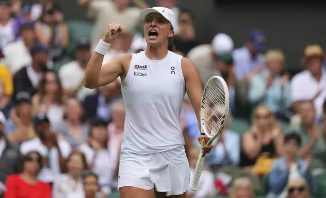 Iga Swiatek of Poland celebrates after beating Danielle Collins of the U.S. during a third round women's singles match at the Wimbledon Tennis Championships in London, Saturday, July 5, 2025. (AP Photo/Kirsty Wigglesworth)