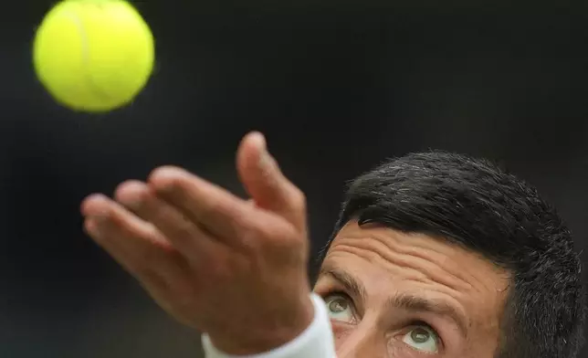 Novak Djokovic of Serbia serves to Miomir Kecmanovic of Serbia during a third round men's singles match at the Wimbledon Tennis Championships in London, Saturday, July 5, 2025. (AP Photo/Kirsty Wigglesworth)