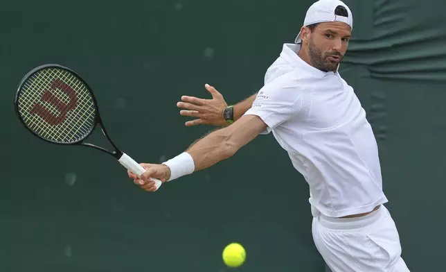 Grigor Dimitrov of Bulgaria returns to Sebastian Ofner of Austria during a third round men's singles match at the Wimbledon Tennis Championships in London, Saturday, July 5, 2025. (AP Photo/Joanna Chan)