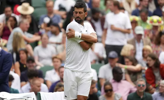 Novak Djokovic of Serbia stretches during a change of ends break as he plays Miomir Kecmanovic of Serbia during a third round men's singles match at the Wimbledon Tennis Championships in London, Saturday, July 5, 2025. (AP Photo/Kirsty Wigglesworth)