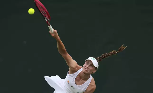 Elena Rybakina of Kazakhstan playing a returns to Clara Tauson of Denmark during their women's singles third round match at the Wimbledon Tennis Championships in London, Saturday, July 5, 2025.(AP Photo/Kin Cheung)