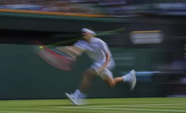Taylor Fritz of the U.S. returns to Alejandro Davidovich Fokina of Spain during a third round singles match at the Wimbledon Tennis Championships in London, Friday, July 4, 2025. (AP Photo/Kin Cheung)