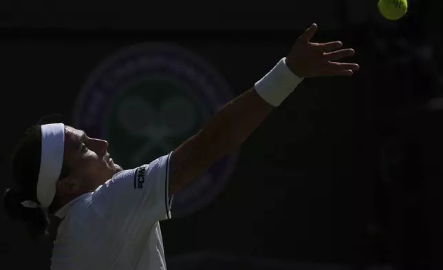Mattia Bellucci of Italy serves to Cameron Norrie of Britain during their men's singles third round match at the Wimbledon Tennis Championships in London, Friday, July 4, 2025.(AP Photo/Joanna Chan)