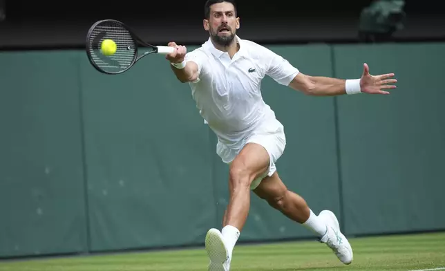Novak Djokovic of Serbia returns to Miomir Kecmanovic of Serbia during a third round men's singles match at the Wimbledon Tennis Championships in London, Saturday, July 5, 2025. (AP Photo/Kirsty Wigglesworth)