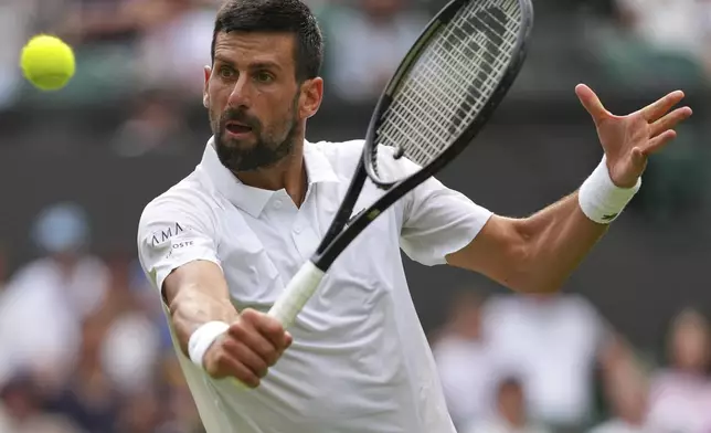 Novak Djokovic of Serbia returns to Miomir Kecmanovic of Serbia during a third round men's singles match at the Wimbledon Tennis Championships in London, Saturday, July 5, 2025. (AP Photo/Kirsty Wigglesworth)