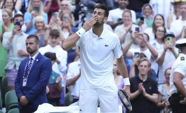 Novak Djokovic of Serbia blows a kiss as he celebrates beating Miomir Kecmanovic of Serbia during a third round men's singles match at the Wimbledon Tennis Championships in London, Saturday, July 5, 2025. (AP Photo/Kirsty Wigglesworth)