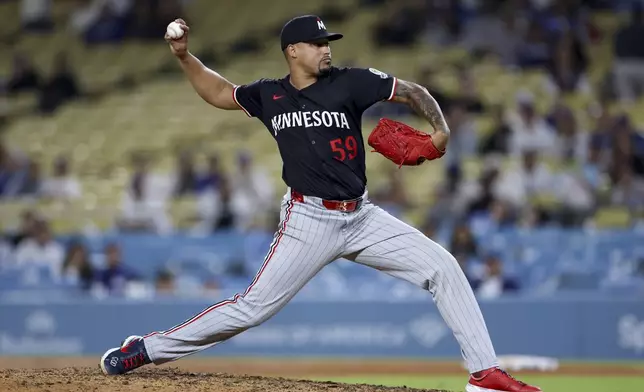 Minnesota Twins relief pitcher Jhoan Duran throws a pitch during the ninth inning of a baseball game against the Los Angeles Dodgers Tuesday, July 22, 2025, in Los Angeles. (AP Photo/Eric Thayer)