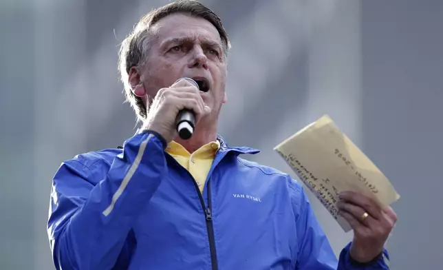 Former President Jair Bolsonaro speaks during a protest against his Supreme Court trial, in which he is accused of involvement in a 2022 coup attempt, in Sao Paulo, Sunday, June, 29, 2025. (AP Photo/Ettore Chiereguini)