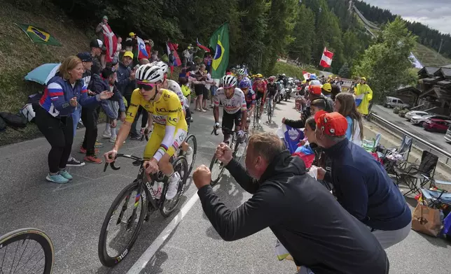 Slovenia's Tadej Pogacar, wearing the overall leader's yellow jersey, climbs during the eighteenth stage of the Tour de France cycling race over 171.5 kilometers (106.6 miles) with start in Vif and finish in Courchevel Col de la Loze, France, Thursday, July 24, 2025. (AP Photo/Thibault Camus)