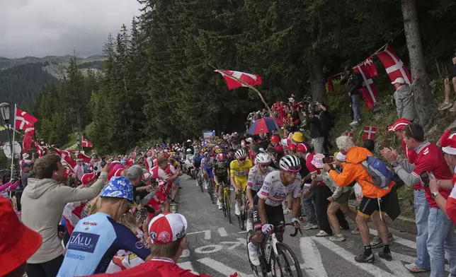 Ecuador's Jhonatan Narvaez and Britain's Adam Yates, first and second, set the pace for their leader Slovenia's Tadej Pogacar, wearing the overall leader's yellow jersey, during the eighteenth stage of the Tour de France cycling race over 171.5 kilometers (106.6 miles) with start in Vif and finish in Courchevel Col de la Loze, France, Thursday, July 24, 2025. (AP Photo/Thibault Camus)
