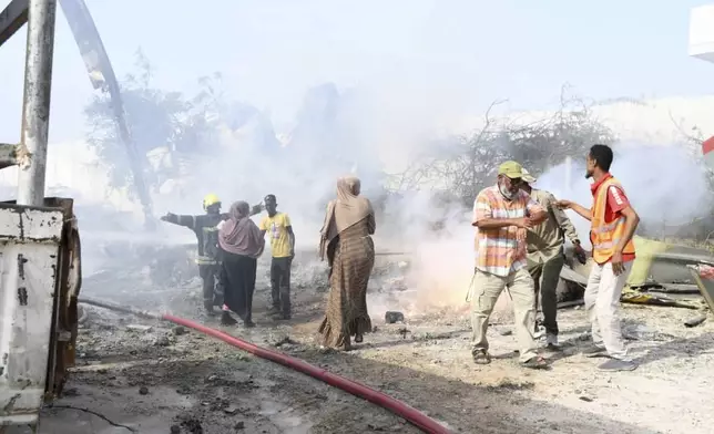 Rescue efforts take place at the site after an African Union military helicopter crashed at Aden Adde airport in Mogadishu, Somalia, on Wednesday, July 2, 2025. (AP Photo)