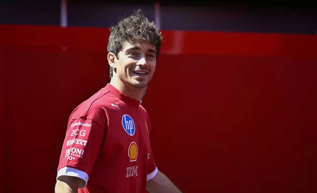 Ferrari driver Charles Leclerc of Monaco smiles in the paddock at the Hungaroring racetrack, in Mogyoród, Hungary, Thursday, July 31, 2025, ahead of the Hungarian Formula One Grand Prix. (AP Photo/Denes Erdos)