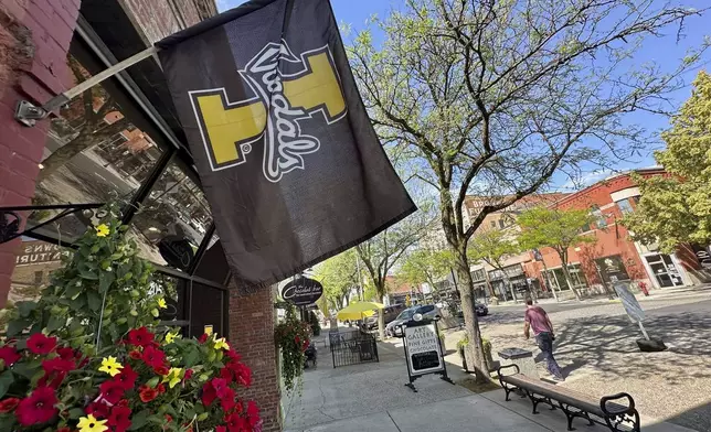 A University of Idaho flag hangs from a storefront in downtown Moscow, Idaho, on Tuesday, July 1, 2025. (AP Photos/Manuel Valdes)